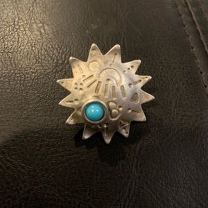 Silver and turquoise pin. Size of a quarter.